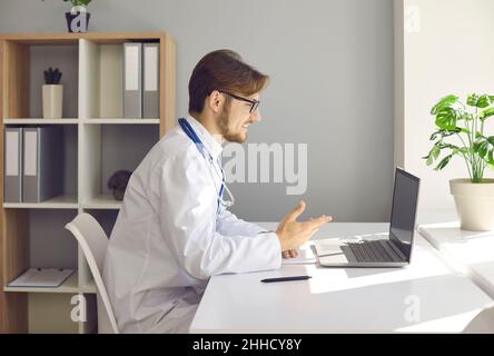 Smiling male doctor have webcam call with patient Stock Photo