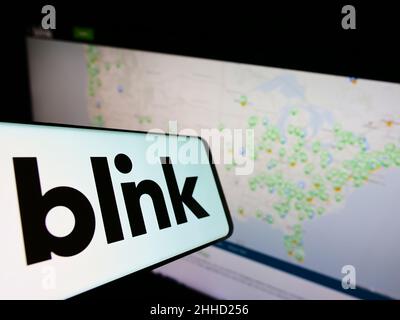 Mobile phone with logo of US company Blink Charging Co. on screen in front of business website. Focus on center of phone display. Stock Photo