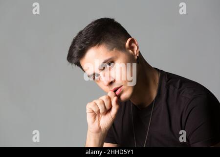 Thoughtful young man with his hands on his head Stock Photo