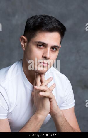 Thoughtful young man with his hands on his head Stock Photo