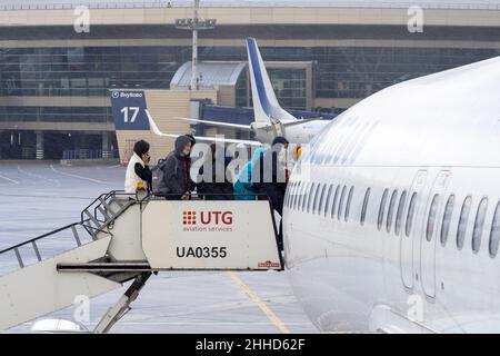 MOSCOW - OCT 19: People on a ladder before flight during cold autumn day at Vnukovo Airport in Moscow, October 19. 2021 in Russia Stock Photo
