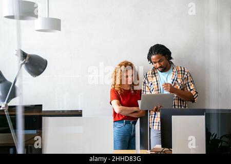 Happy successful young business colleagues working in office. Business people technology concept Stock Photo