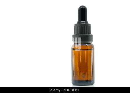 Close-up image of brown glass bottle dropper bottle. isolated dropper bottle on white background. Black color dropper cap with cleared-glass brown col Stock Photo