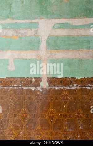 home decorating - decorating old house - wallpaper removed to reveal vintage brown wallpaper  and old painted walls filled and sanded - UK Stock Photo