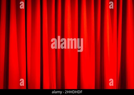 Red closed curtain with a light spot use for background Stock Photo