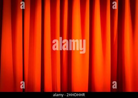 Red closed curtain with a light spot use for background Stock Photo
