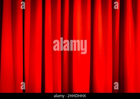 Red closed curtain with a light spot use for background Stock Photo