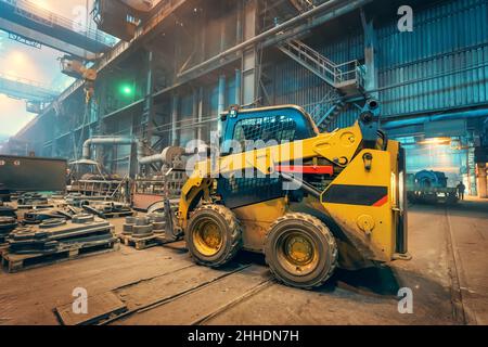 Electric forklift loader inside industrial factory warehouse interior. Stock Photo
