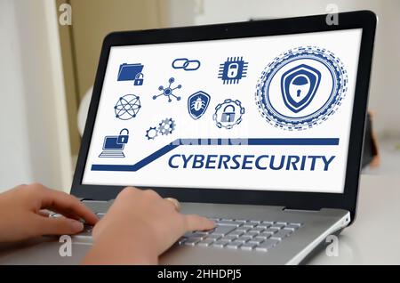 Hands on a laptop with screen showing cybersecurity concept Stock Photo