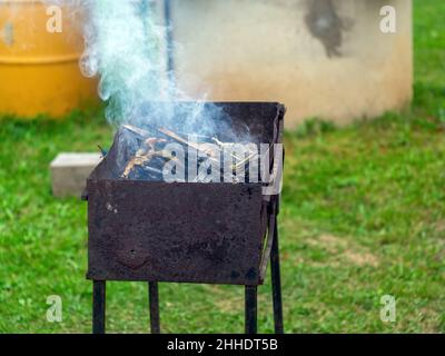 smoke comes from the barbecue in the village, in autumn Stock Photo