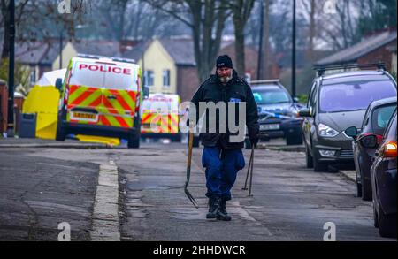 Greater Manchester Police officers searching for evidence at the scene on Thirlmere Avenue in Stretford, Manchester, after a 16-year-old boy, named by police as Kennie Carter, was fatally stabbed at around 7pm on Saturday. Picture date: Monday January 24, 2022. Stock Photo