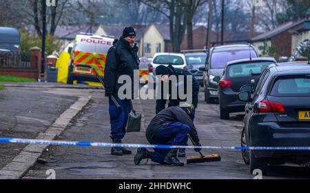 Greater Manchester Police officers searching for evidence at the scene on Thirlmere Avenue in Stretford, Manchester, after a 16-year-old boy, named by police as Kennie Carter, was fatally stabbed at around 7pm on Saturday. Picture date: Monday January 24, 2022. Stock Photo