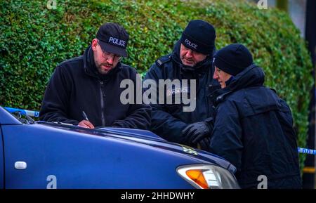 Greater Manchester Police officers searching for evidence at the scene on Thirlmere Avenue in Stretford, Manchester, after a 16-year-old boy, named by police as Kennie Carter, was fatally stabbed at around 7pm on Saturday. Picture date: Monday January 24, 2022. Stock Photo