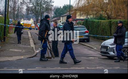 Greater Manchester Police officers searching for evidence at the scene on Thirlmere Avenue in Stretford, Manchester, after a 16-year-old boy, named by police as Kennie Carter, was fatally stabbed at around 7pm on Saturday. Picture date: Monday January 24, 2022. Stock Photo