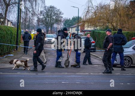 Greater Manchester Police officers searching for evidence at the scene on Thirlmere Avenue in Stretford, Manchester, after a 16-year-old boy, named by police as Kennie Carter, was fatally stabbed at around 7pm on Saturday. Picture date: Monday January 24, 2022. Stock Photo