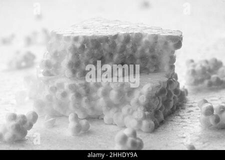 Stack of broken pieces of white styrofoam on the sheet of white styrofoam Stock Photo