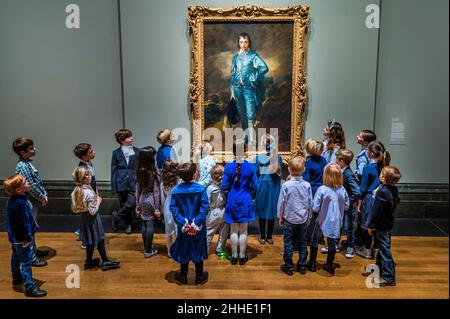 London, UK. 24th Jan, 2022. The Blue Boy by Thomas Gainsborough appears at the National Gallery 100 years, to the day, since it was last seen in the country. Pictured with children of National Gallery staff and of the US Embassy in London. The work is owned by the Huntington Library, Art Museum, and Botanical Gardens in San Marino, California. The free exhibition in Room 46 will see The Blue Boy shown alongside a select group of five paintings that demonstrate Gainsborough's ongoing interest in Van Dyck's paintings. Credit: Guy Bell/Alamy Live News Stock Photo