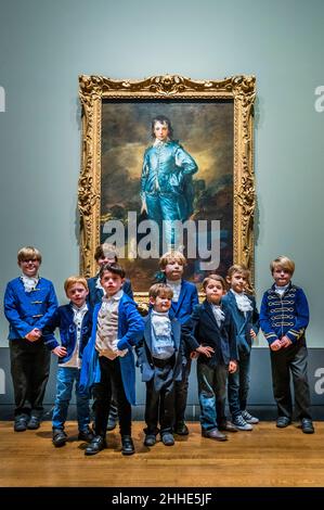 London, UK. 24th Jan, 2022. The Blue Boy by Thomas Gainsborough appears at the National Gallery 100 years, to the day, since it was last seen in the country. Pictured with children of National Gallery staff and of the US Embassy in London. The work is owned by the Huntington Library, Art Museum, and Botanical Gardens in San Marino, California. The free exhibition in Room 46 will see The Blue Boy shown alongside a select group of five paintings that demonstrate Gainsborough's ongoing interest in Van Dyck's paintings. Credit: Guy Bell/Alamy Live News Stock Photo