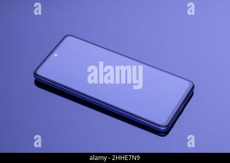 Smartphone screen close-up on a dark violet glossy background. Template with copy space for text. Modern mockup, advertising layout Stock Photo