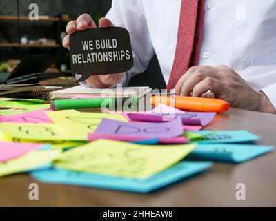 A Manager shows sign We build relationships. Stock Photo