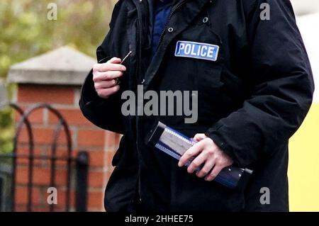 Greater Manchester Police officers searching for evidence at the scene have a knife in a plastic tube, on Thirlmere Avenue in Stretford, Manchester, after a 16-year-old boy, named by police as Kennie Carter, was fatally stabbed at around 7pm on Saturday. Picture date: Monday January 24, 2022. Stock Photo