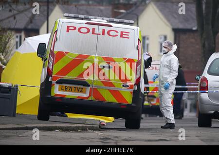 Greater Manchester Police officers searching for evidence at the scene on Thirlmere Avenue in Stretford, Manchester, after a 16-year-old boy, named by police as Kennie Carter, was fatally stabbed at around 7pm on Saturday. Picture date: Monday January 24, 2022. Stock Photo