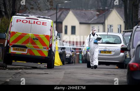 Greater Manchester Police officers searching for evidence at the scene on Thirlmere Avenue in Stretford, Manchester, after a 16-year-old boy, named by police as Kennie Carter, was fatally stabbed at around 7pm on Saturday. Picture date: Monday January 24, 2022. Stock Photo