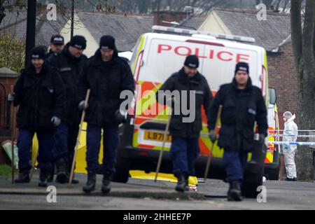 Greater Manchester Police officers searching for evidence at the scene on Thirlmere Avenue in Stretford, Manchester, after a 16-year-old boy, named by police as Kennie Carter, was fatally stabbed at around 7pm on Saturday. Picture date: Monday January 24, 2022. Stock Photo