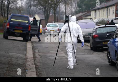 Greater Manchester Police officers searching for evidence at the scene on Thirlmere Avenue in Stretford, Manchester, after a 16-year-old boy, named by police as Kennie Carter, was fatally stabbed at around 7pm on Saturday. Picture date: Monday January 24, 2022. Stock Photo