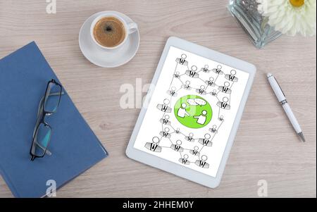 Top view of a desk with social network concept on a digital tablet Stock Photo