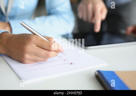 Businessmen make up a strategy, write down a list of options Stock Photo