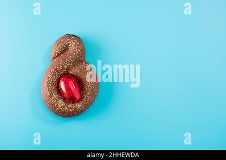 Easter cake with surprise egg on blue background Stock Photo