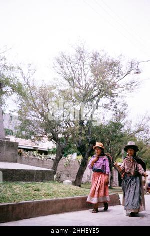 Two women walking in park one spinning, Ayacucho, Peru, South America 1962 Stock Photo