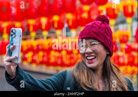 London, UK. 24th Jan, 2022. Final preparations as lanterns are put up in Chinatown - celebrations for Chinese New Year are once again going to be subdued this year due to the Omicron Variant of Covid 19. Thes will mark the start of the year of the tiger. Credit: Guy Bell/Alamy Live News Stock Photo