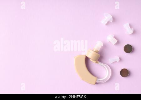 Concept of health care with hearing aid on purple background Stock Photo