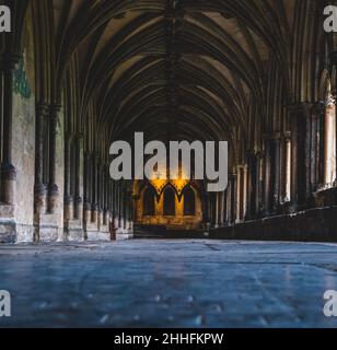 Low angle shot from the shiny stone floor of the cloisters at Norwich Cathedral in England. Stock Photo
