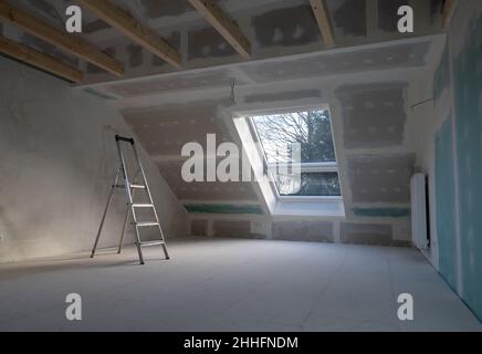 Drywall plastering during a house renovation in the attic. Stock Photo