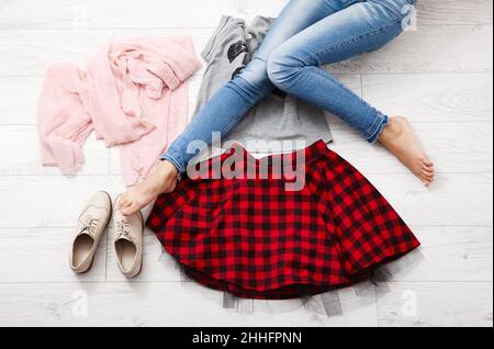 Stylish outfit and female legs on white wooden background. Top view Stock Photo