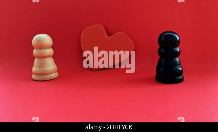 Black and white pawns falling in love. Love concept on Valentine's day. Stock Photo