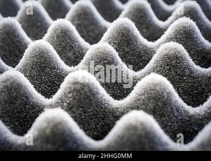 Light play on black egg crate foam.  Close up view. Stock Photo