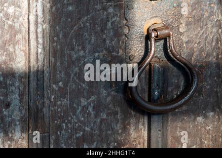 Heavy duty metal door handle on old wooden door Stock Photo