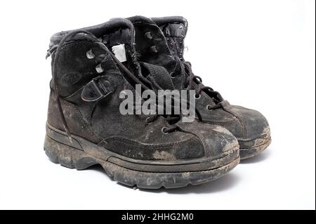 pair of dirty walking boots on white background Stock Photo