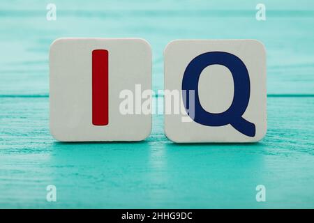 Intelligence quotient. Word IQ on blue wooden background. Copy space. Mock up. School and education concept Stock Photo