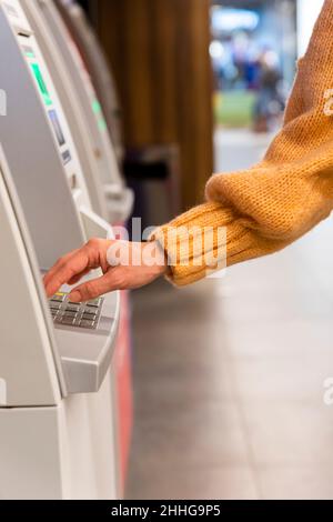 Close up of a womans hand entering secret code on the keypad of an ATM machine Stock Photo