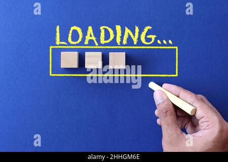 Top view image of hand draw loading bar and wooden cubes on blue background Stock Photo