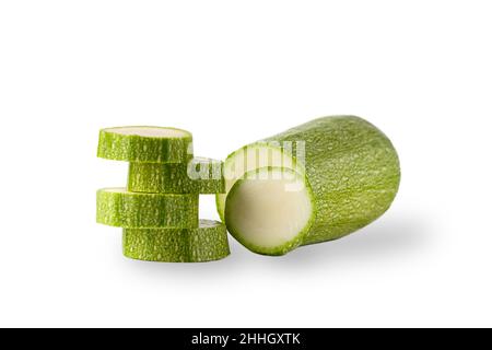 Healthy vegetables. Fresh green zucchini with a slice on a white plate. Stock Photo