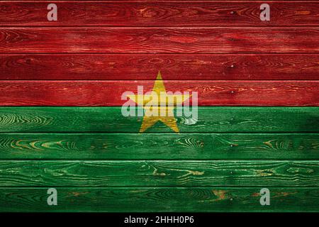 The national flag of Burkino Faso is painted on a camp of even boards nailed with a nail. The symbol of the country. Stock Photo