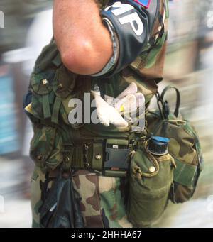 MP saluting. MP National Guard US Army Military Police armband. Soldier standing at attention, combat ready and on duty in camouflage clothing. Stock Photo