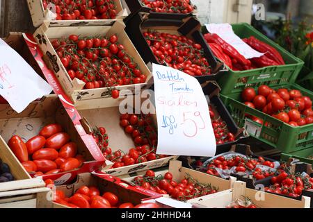 Munich, Germany - July 07, 2018: Trade on the streets of Munich vegetables and fruits in the warm season. Shop Window, Boxes with Ripe Tomatoes Stock Photo