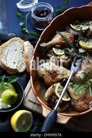 Baked chicken drumsticks with lemon and olives. Directly above. Stock Photo